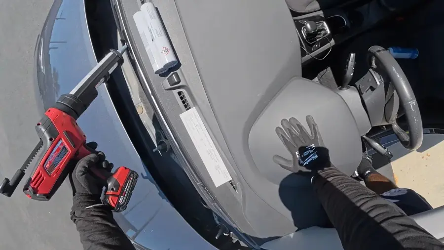hail-damaged windshield before repair